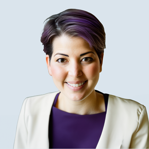 Rachel is a light-skinned woman with brown eyes and short, purple hair. She has round, rosy cheeks and is smiling. She is wearing a purple top and beige blazer. She is pictured against a blue-grey background.